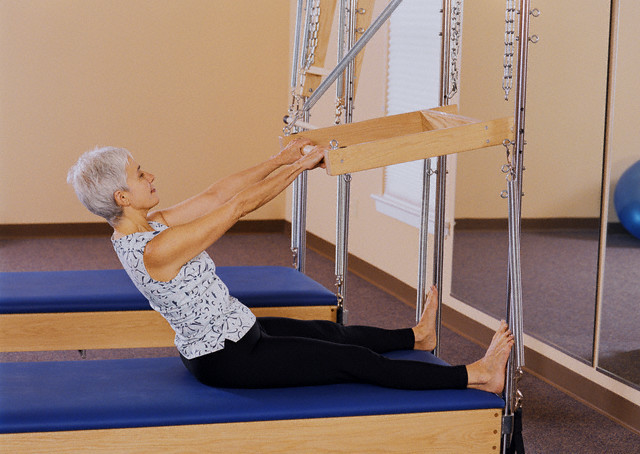 USA --- Woman Practicing Pilates --- Image by © ROB & SAS/Corbis